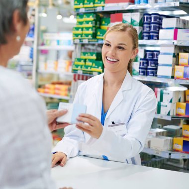 Pharmacist, cashier and shopping for medicine in store with pills or drugs in box for healthcare. Happy, woman and pharmacy customer with sale advice, offer or choice of supplements at drugstore.