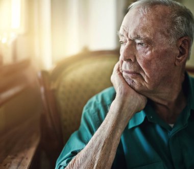 Senior, man and thinking with depression for memory in retirement home with remember, nostalgia or reflection on sofa. Elderly, person and sad with alzheimers, grief and thoughtful on couch or mockup.