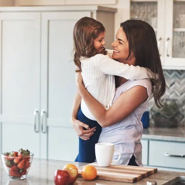 stock image Care, mom and hug with girl, kitchen or smile in weekend, house and kid with love. Bonding, child and mother with daughter, embrace and together in morning, happy or breakfast in apartment for peace.