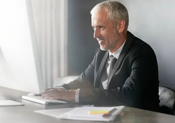 stock image Businessman, mature and man or busy on computer, attorney and email client on case progress in law firm. Office, networking and search for pleadings info, professional and internet for legal advice.