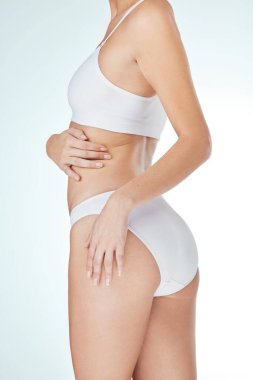 Woman, underwear and body in studio for health, wellness and self care with model aesthetic. Girl, lingerie and natural skin with sexy butt or glutes for slimming transformation on white background.