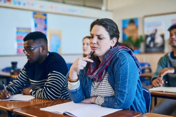 stock image Student, thinking and woman reading in university classroom for education, test or exam. Idea, college and study in lecture for problem solving, doubt or brainstorming solution for learning knowledge.