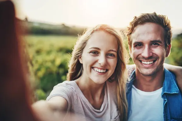 Stock image Couple, portrait and selfie on farm in nature for agriculture, sustainable farming and happy for harvest season with post. Man, woman and photography on land for environment, memory and personal blog.