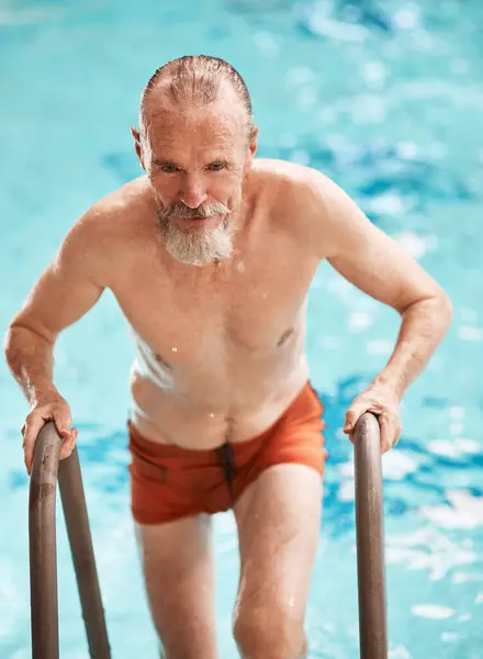 stock image Senior man, swimming pool and exercise for physical therapy, physiotherapy and health. Elderly male person, aquatic center and hydrotherapy for workout, retirement and active cardio mobility.