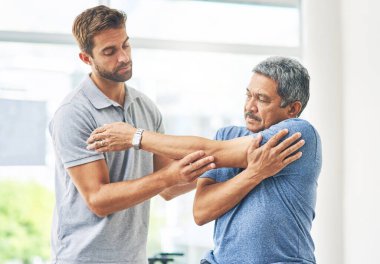 Fizyoterapist, kıdemli adam ve destek için esneme, yaşlı bakımı ve sağlık ve zindelik. Kayropraktik, rehabilitasyon kliniği ya da huzurevi emeklisi.