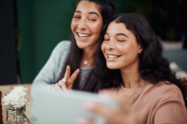 Kadınlar, kahve dükkanında selfie, güzel anılar ve teknolojiyle sosyal medya için gülümseyin ve barış işareti yapın. Mutlu, aile bağları ve restoranda fotoğrafçılık, birleşme ya da hafta sonu İspanya 'da kız kardeşler..