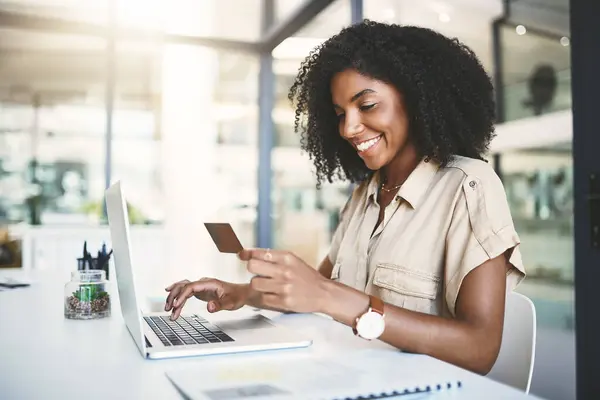 stock image Office, black woman and credit card with laptop for typing, fintech payment and online shopping with smile. Happy, business person and computer for banking, details and transaction on financial app.