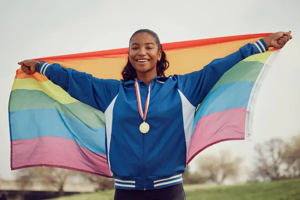 stock image LGBTQ, flag and portrait of woman with medal for winning, champion and pride in sports victory. Queer, athlete and nature with award at competition for success, inclusivity and achievement in Paris.