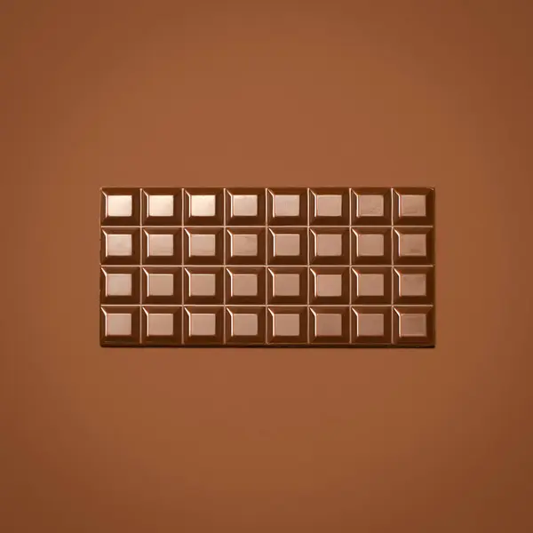 stock image Sweet, chocolate and slab on studio background for snack on diet, metabolism boost and skin health benefits. Brown, candy and bar of cocoa for minerals or stress relief, improve blood flow and food