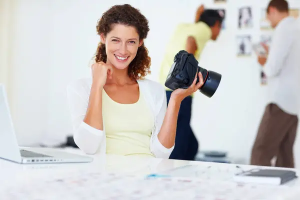 stock image Happy, woman and photographer with portrait in office, camera and laptop with catalog for research trend topic. Female visual artist, creative agency and smile for project management or editing photo.