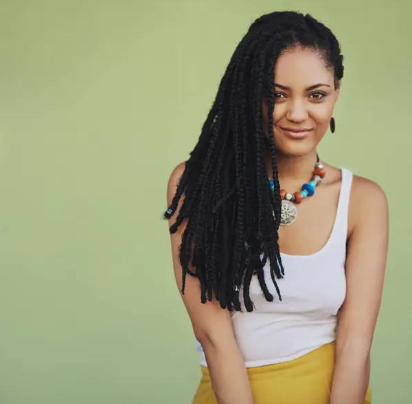 stock image Dreadlocks, fashion and portrait of woman in studio for summer clothes, necklace and trendy style. Confident, smile and person with pride for outfit, jewellery and accessories on green background.