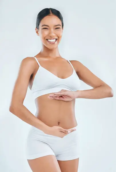 stock image Body, digestion and hands on stomach for woman in studio, nutrition and gut health on white background. Wellness, healthy goals and portrait of female model, diet and balance fitness lifestyle.