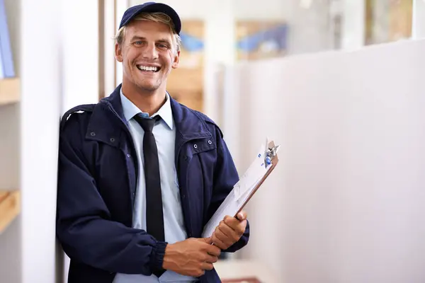 stock image Portrait, smile and retail with courier man at office for distribution, shipping or service. Ecommerce, logistics or delivery and happy young postal worker with clipboard for manifest or order.