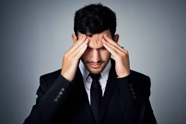 stock image Stress, headache and businessman in studio for crisis with crash in financial market with investment loss. Migraine, mistake and male broker with bankruptcy for finance fail by gray background