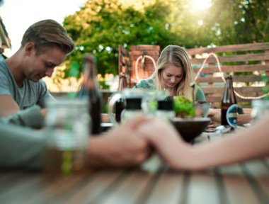 People, holding hands and praying for dinner with gratitude, grace and grateful for meal on table. Christian, friends and food with spiritual connection for thanksgiving, social gathering and reunion. clipart