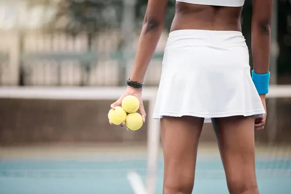 stock image Tennis ball, woman and back on outdoor court for training, match and competition and set game. Hands, sport and workout gear for wellness, health and rally for fitness at country club ready to play.