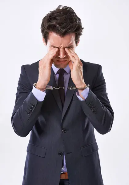 stock image Businessman, handcuffs and fraud with stress for crime or ponzi scheme on a white studio background. Frustrated man or employee in arrest or restraint for embezzlement nepotism lawsuit or corruption.