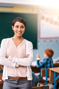 Woman, teacher and happy with arms crossed in classroom for teaching, learning and education in elementary school. Female person, professional and smile or proud in confidence with career growth. clipart