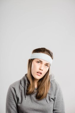 Woman, lost and annoyed face in studio for rude personality, negative reaction and bored with headband. Female person, ignore and disappointed facial expression on white background for frustrated. clipart