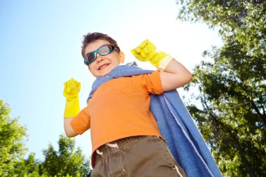 Fantasy, portrait and superhero with boy outdoor for child development, games or growth in summer. Cape, costume and sunglasses with smile of happy kid in garden for crime fighting or defending. clipart