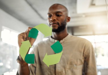 Business, black man and recycle logo on glass wall with marker for eco friendly and environment at office. Male person, employee and overlay in brainstorming or planning for green and sustainability. clipart