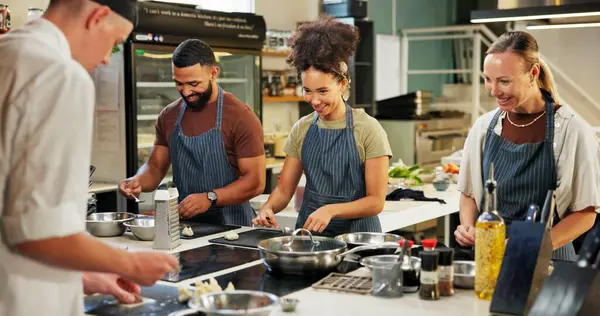 Cooking, course and chef in kitchen with group for meal preparation, teaching gourmet recipe or learning skills. Culinary class, people and mentor with lesson on food education and cuisine knowledge.