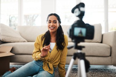 Woman, content creator and apartment with digital camera for podcast, vlogging and recording video. Female person, home and living room as influencer with live screaming, broadcast and internet. clipart