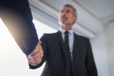 Handshake, partnership and welcome with business people in corporate workplace for deal from below. Agreement, B2B or thank you with employee man shaking hands and colleague in professional office. clipart