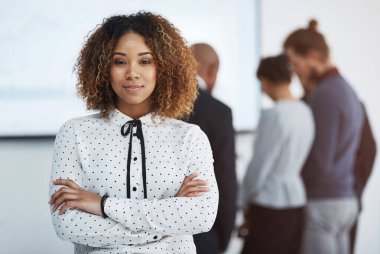 Arms crossed, company and portrait of business woman in boardroom of office with colleagues for meeting. Confident, creative and mission with design employee in workplace for upskill training. clipart