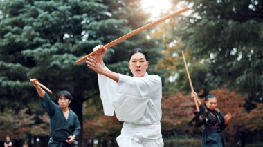 Wooden sword, Japanese people and outdoor in training, exercise and sports for martial arts or aikido. Students, weapon and heritage for challenge, combat and practice as defense technique or bojutsu. clipart