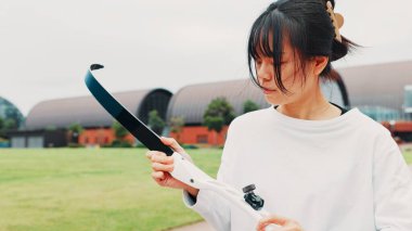 Archery, sport and woman with bow on field for shooting practice, martial arts tradition or getting ready. Japanese culture, archer and equipment safety for kyudo, precision lesson or target training. clipart