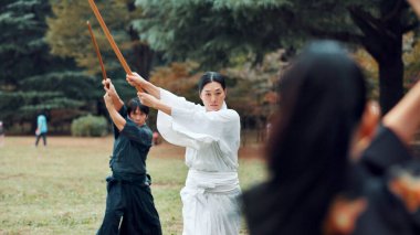 Bokken, Japanese culture and outdoor for martial arts in training, exercise or sports as athlete. People, weapon and heritage for challenge, combat and practice as self defense technique with bojutsu. clipart