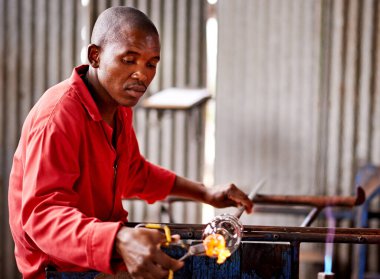 Glass blowing, small business and black man in workshop for creative artist, craft and handmade shape. Art, product process and glassblower in factory for sustainable project, design and heat tools. clipart