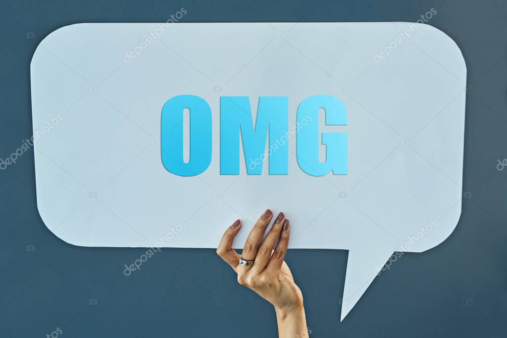 Woman, hand and speech bubble with OMG for comment, social media or feedback on a blue studio background. Closeup of female person with sign for review, text or message of notification or alert.