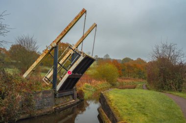 Bridge 23 in a raised position on the Caldon Canal waterway at Stockton Brook during autumn. clipart