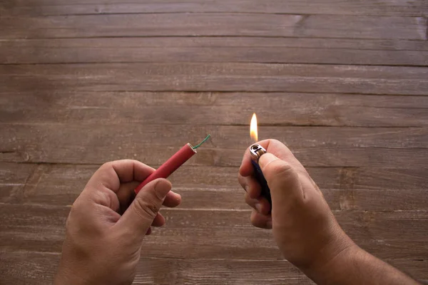 stock image Image of the hands of a man who lights the fuse of a firecracker with a lighter. Reference you have celebrations and the danger of the barrels