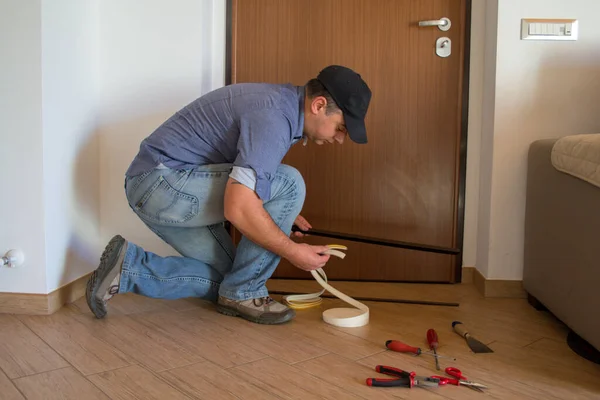 Image Handyman Installing Seals Door Sills Improve Thermal Insulation House Imagen de stock