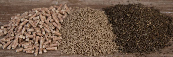 Image of a small pile of pellets, peanuts and olive pomace. Different types of heating fuels for biomass boilers. Horizontal banner