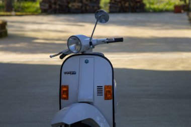 Close-up image of a Piaggio Vespa, parked in the driveway of a house in Italy. 02/01/2023 Florence Tuscany Italy