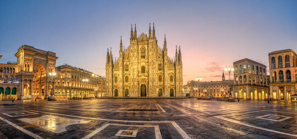 Panoramic view of Piazza del Duomo square with Milan Cathedral, Duomo di Milano, and Galleria Vittorio Emanuele II, Italy, on sunrise. Milan Cathedral is one of the largest churches in the world.