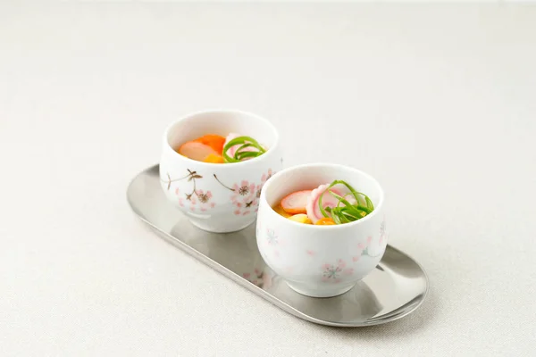 Chawanmushi, Japanese Savory Steamed Egg Custard with Fish Ball and Narutomaki Topping. Copy Space for Text