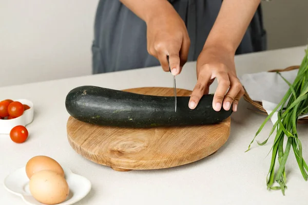 Slice Green Zucchini, Cooking Process in the Kitchen. Female Cut Vegetable on Wooden Board