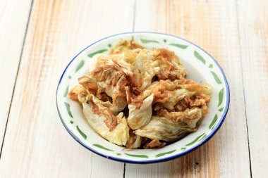 Kol Goreng or Fried Cabbage, Indonesian Side Dish Menu for Penyetan. On Wooden Table 