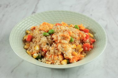 Authentic Yangzhou Chinese Fried Rice with Egg and Vegetable, Isolated on Marble Table 