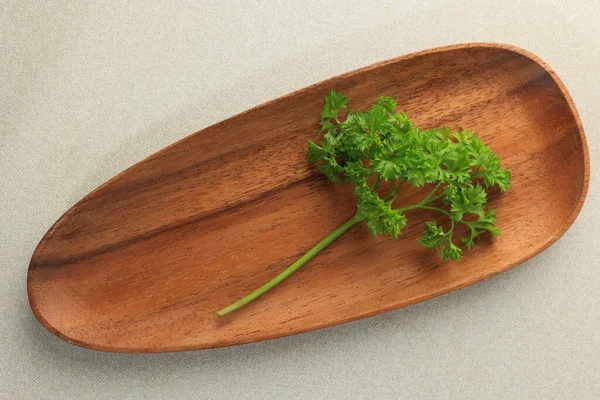 Fresh italian Parsley on Wooden Plate, Top View on the Table. Green Parsley.