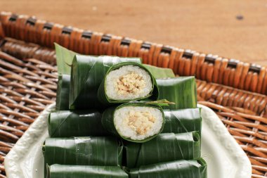 Lemper is Indonesian Traditional Dish Made from Glutinous or Sticky Rice, Steamed with Coconut Milk, with Chicken Floss Inside and Wrapped with Banana Leaf.
