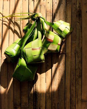 Raw Ketupat and Ied al Fitr Cake (Kue Lebaran) Food Festive for Family in Indonesian or Malaysia Moslem Culture. Copy Space for Text 