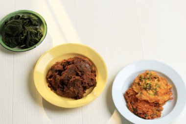 Various Homemade Masakan Padang or Minang Cuisine on WHite Background with Copy Space. Popular as Nasi Padang.