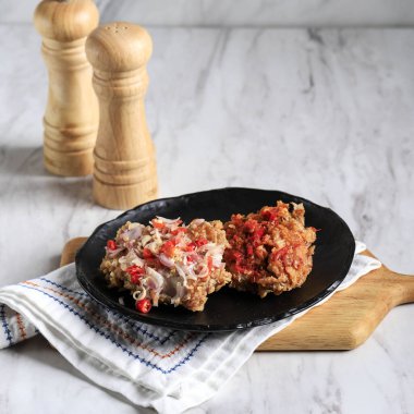 Two Varian of Ayam Geprek. Ayam Geprek is Popular Street Food in Indonesia. Made from Crispy Chicken Smashed in Sambal Bawang or Sambal Matah