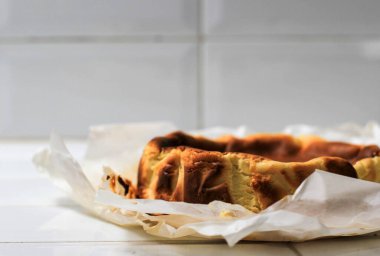 Selected Focus Basque Burnt Cheese Cake on White Kitchen Background, Viral Cheese Cake